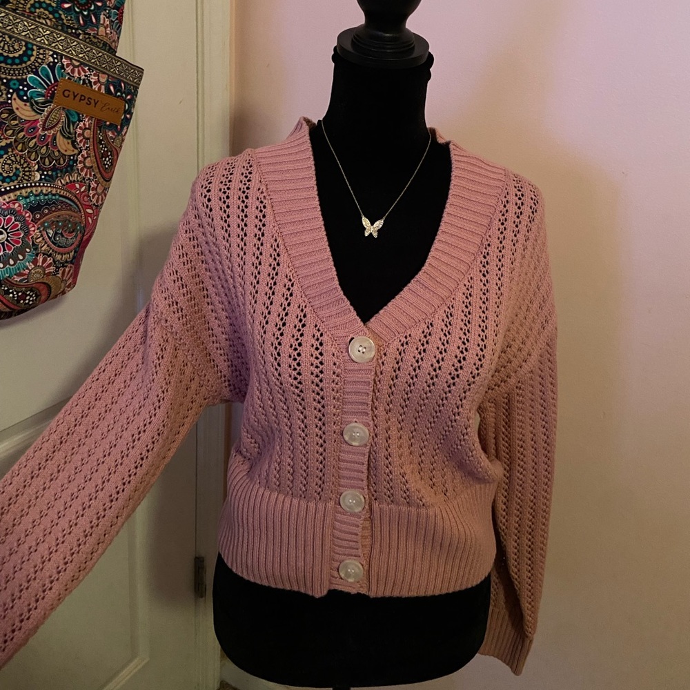 Pink cropped sweater.
